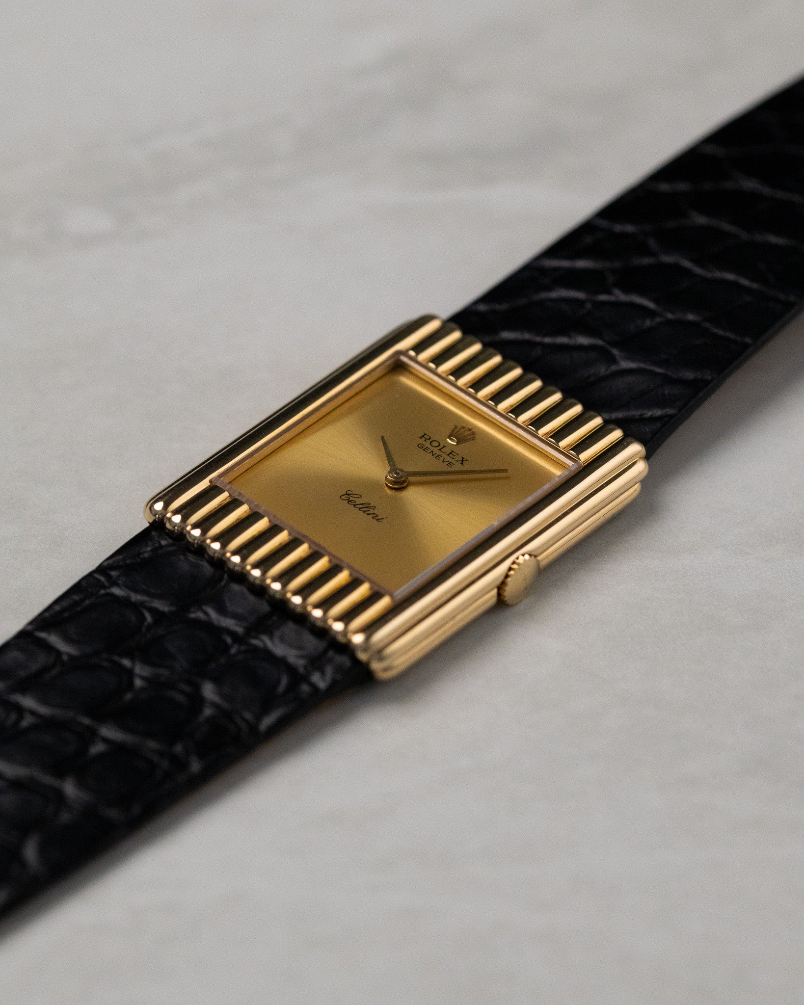 Angled front view of Rolex Cellini Ref. 4016 in 18K yellow gold showing gold dial and rare vertical ribbed rectangular case