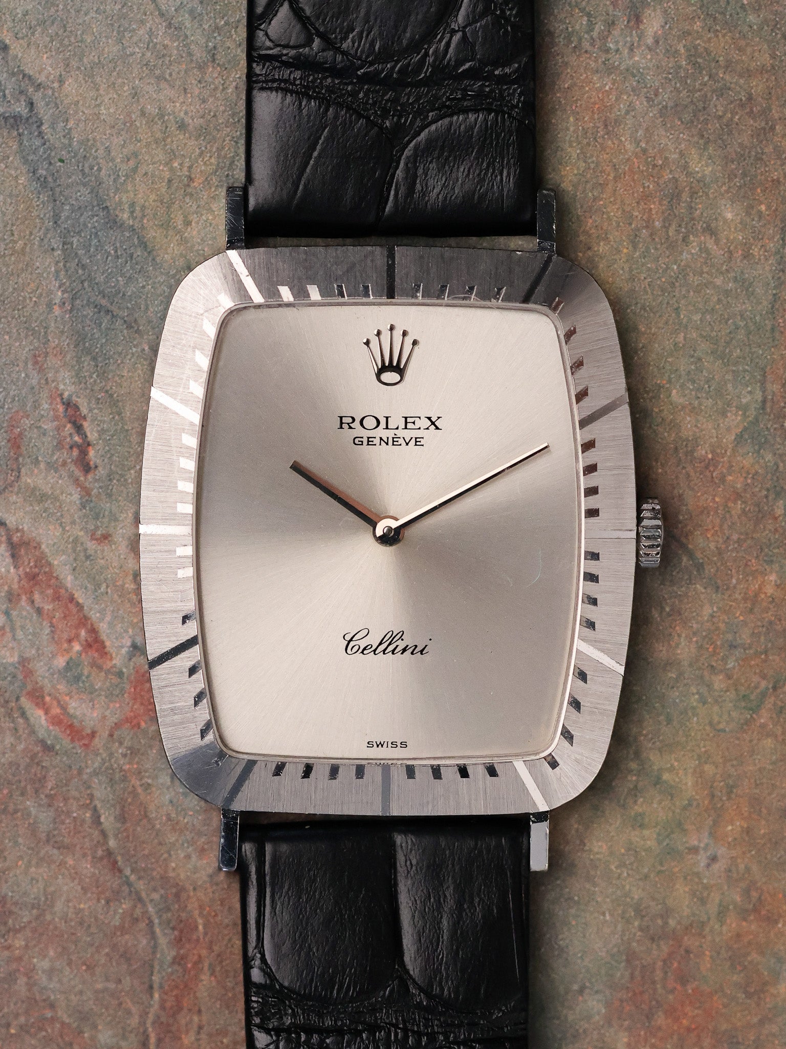 Close-up front view of Rolex Cellini 4087 showing cushion-shaped white gold case, radial brushed bezel detailing, and minimalist silver dial.