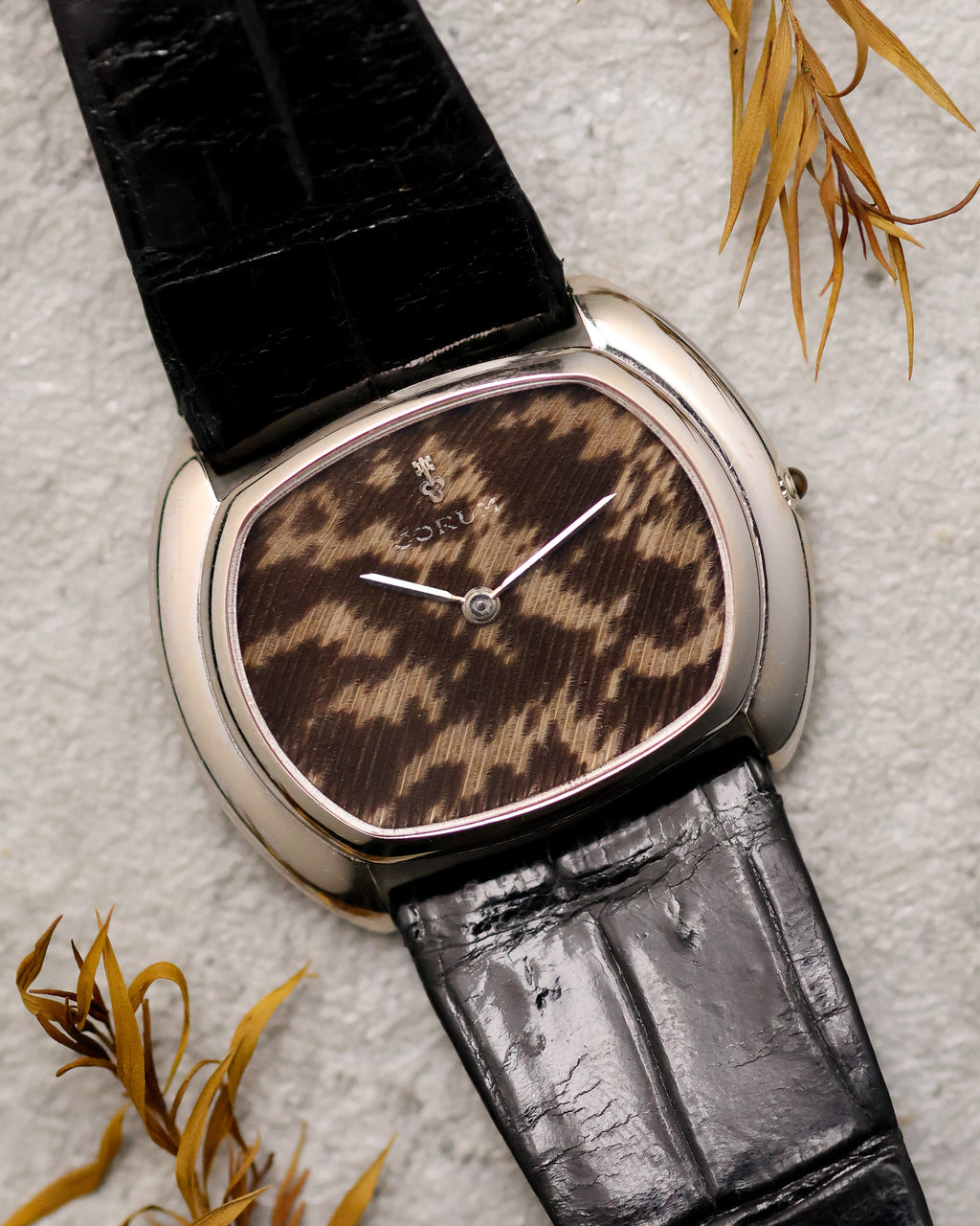Corum Ref. 27119 dress watch with guinea fowl feather dial in 18K white gold case on black leather strap.