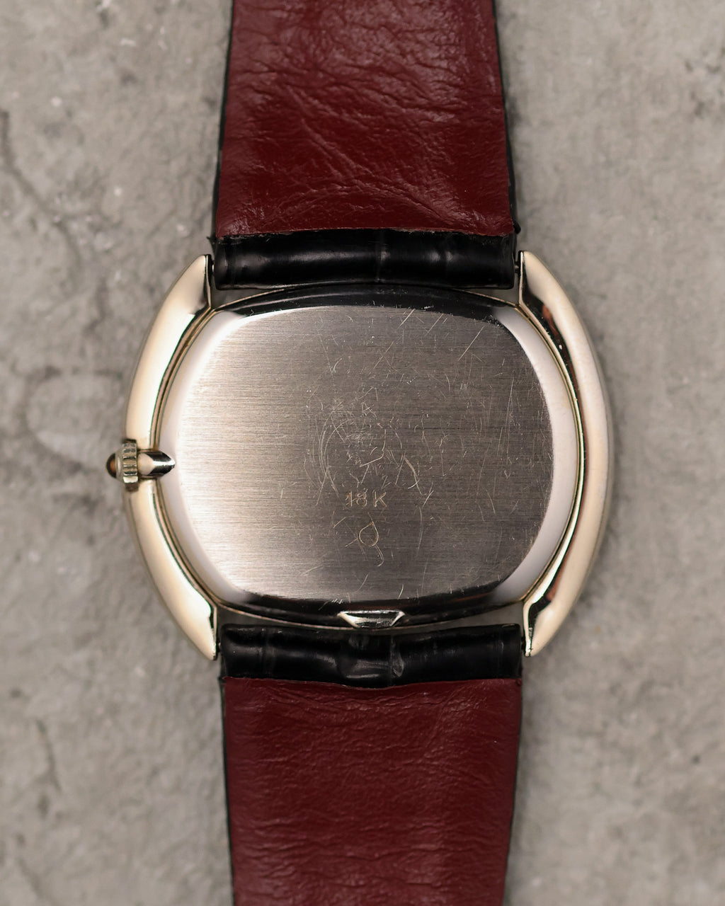 Caseback of Corum Ref. 27119 in 18K white gold with brushed finish and gold hallmark.