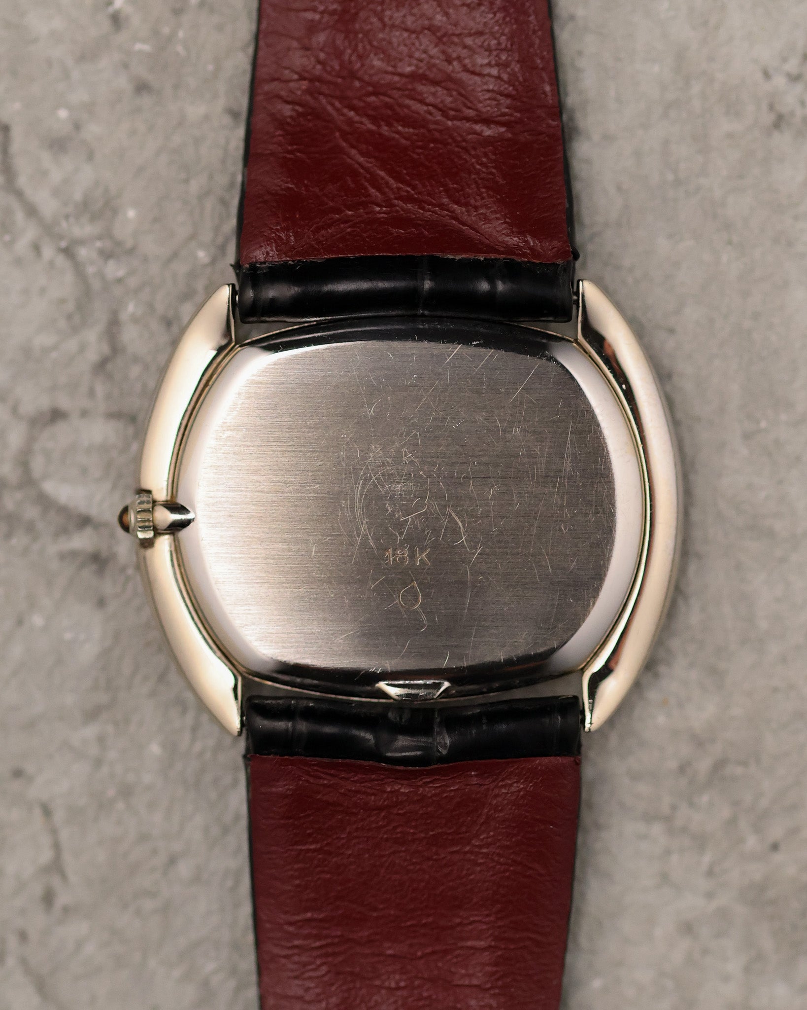 Caseback of Corum Ref. 27119 in 18K white gold with brushed finish and gold hallmark.