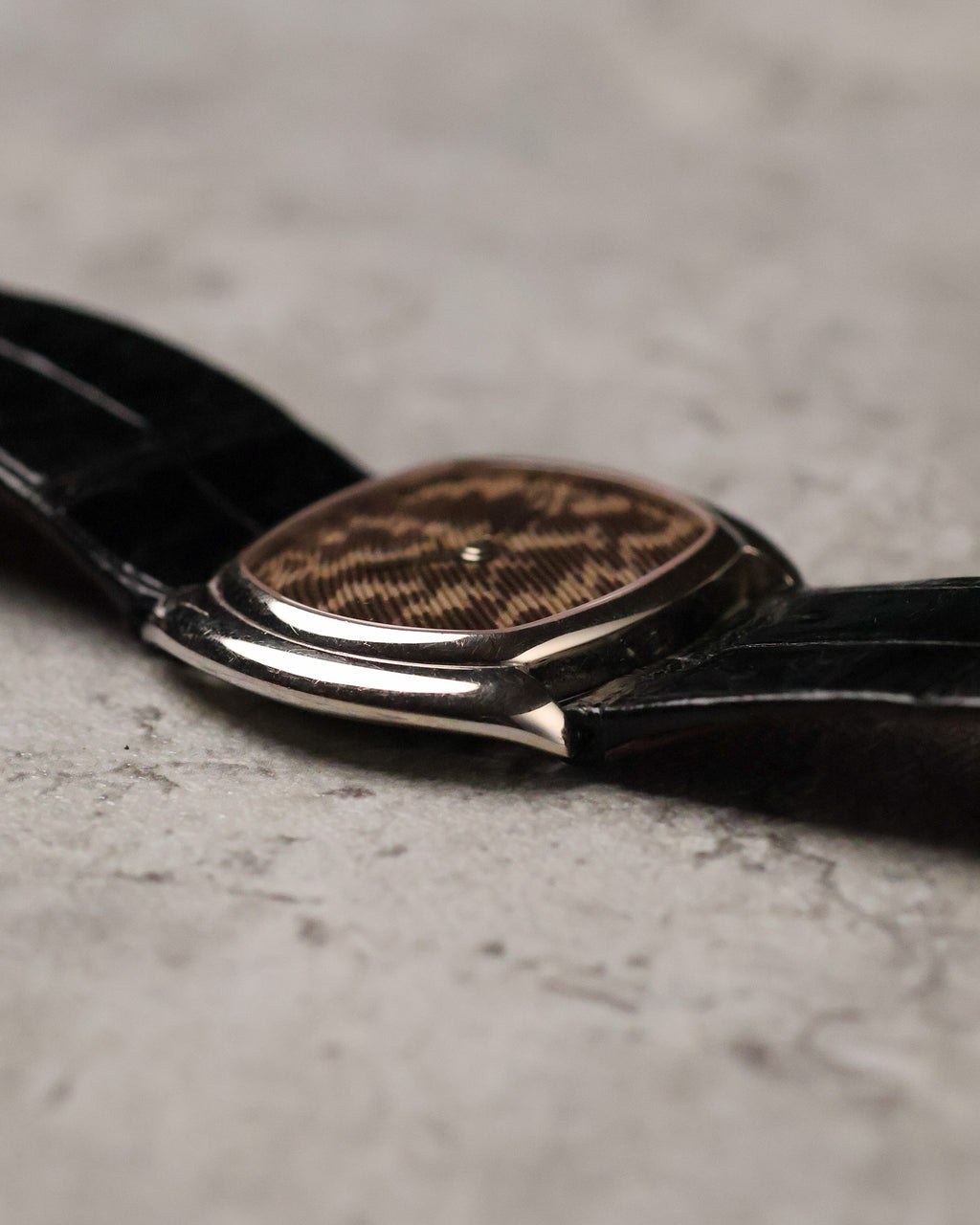 Side profile of Corum Ref. 27119 showing slim white gold case and curved cushion-style shape.