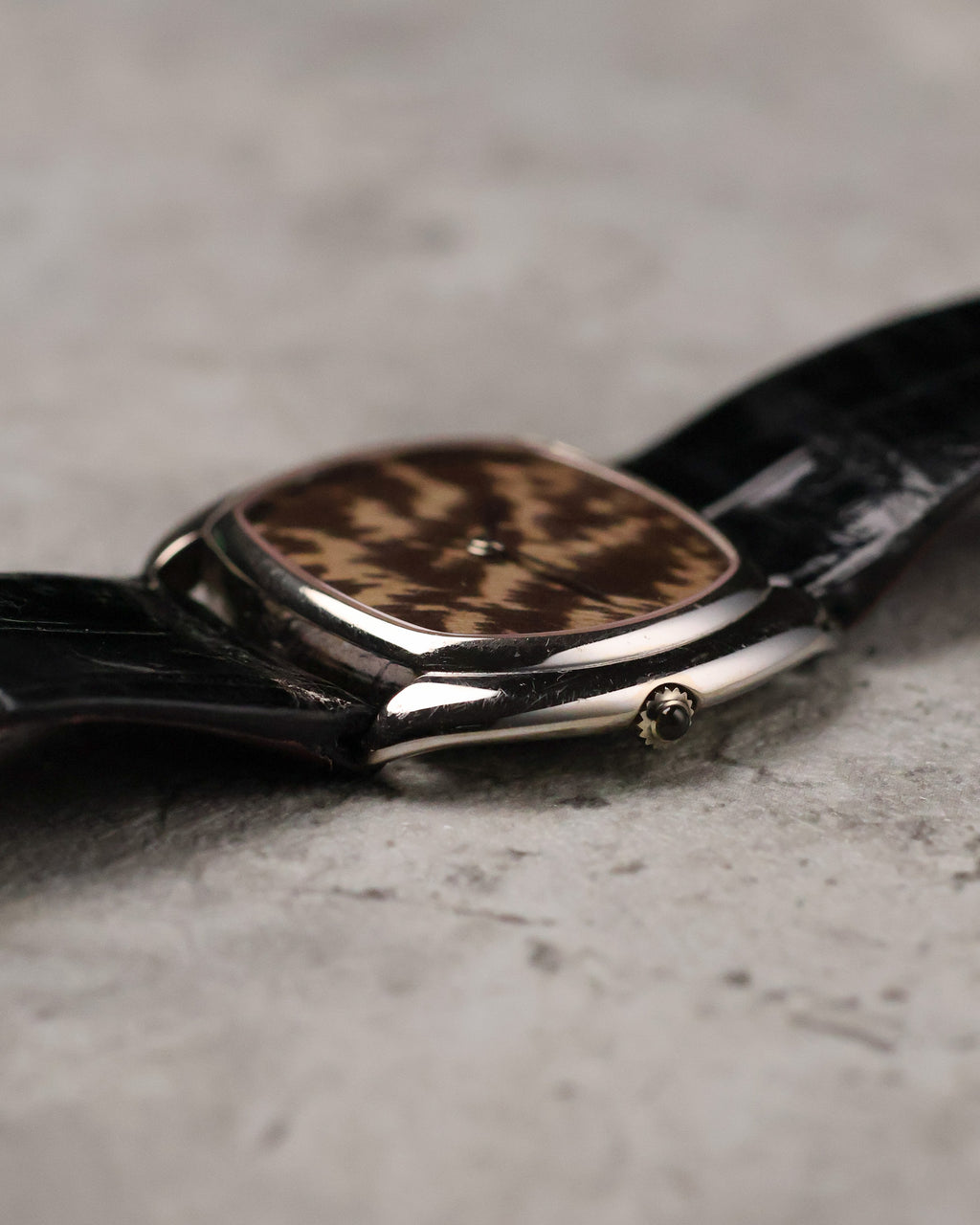 Crown-side profile of Corum white gold case highlighting polished surfaces and thin case construction.