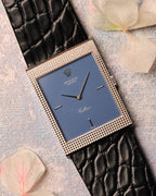 Front view of Rolex Cellini Ref. 4127 in 18K white gold with matte blue dial and Clous de Paris hobnail case, fitted on black leather strap.