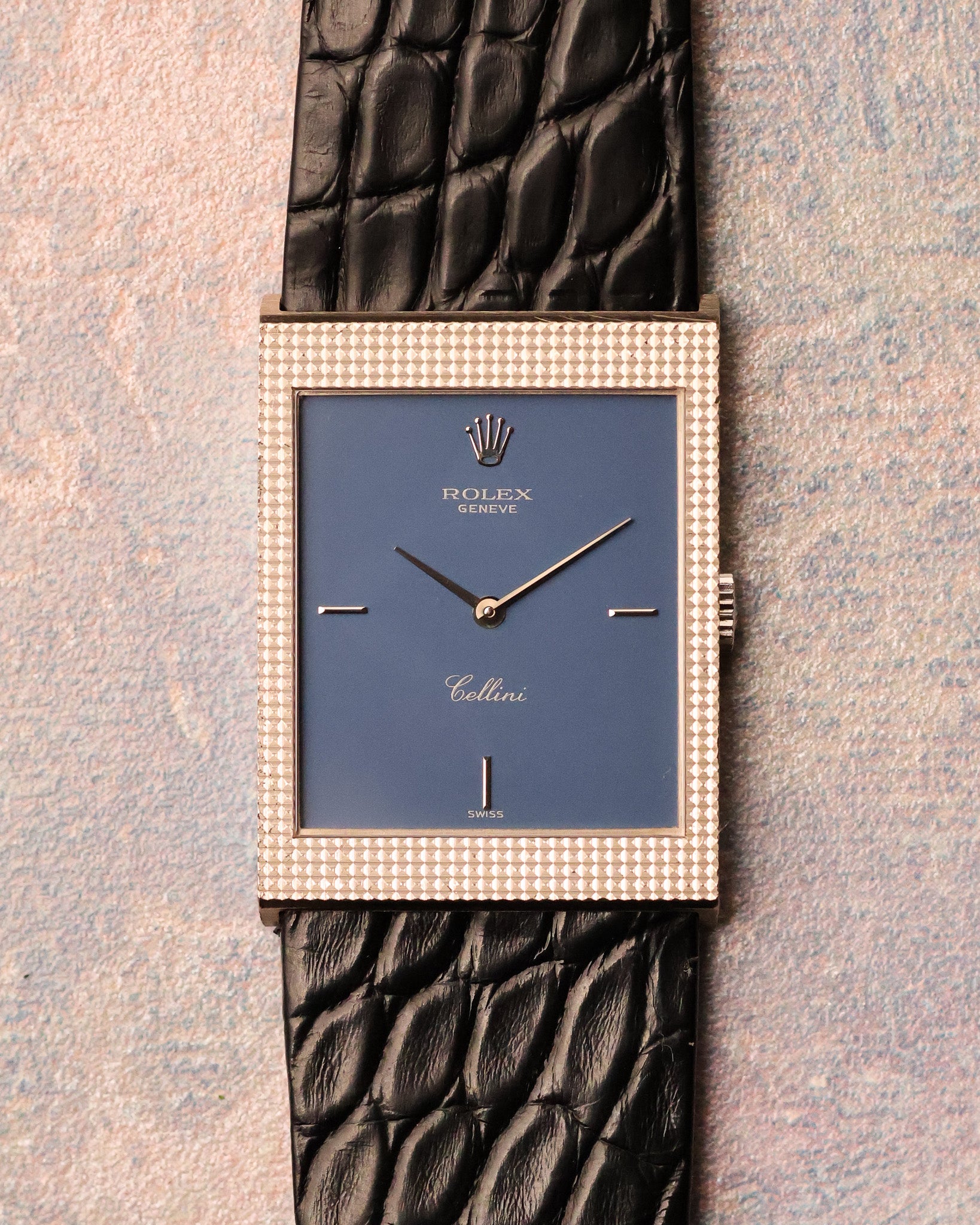 Straight-on dial view showing the matte blue Rolex Cellini dial, applied baton markers, and sharply defined hobnail engraved white gold case.