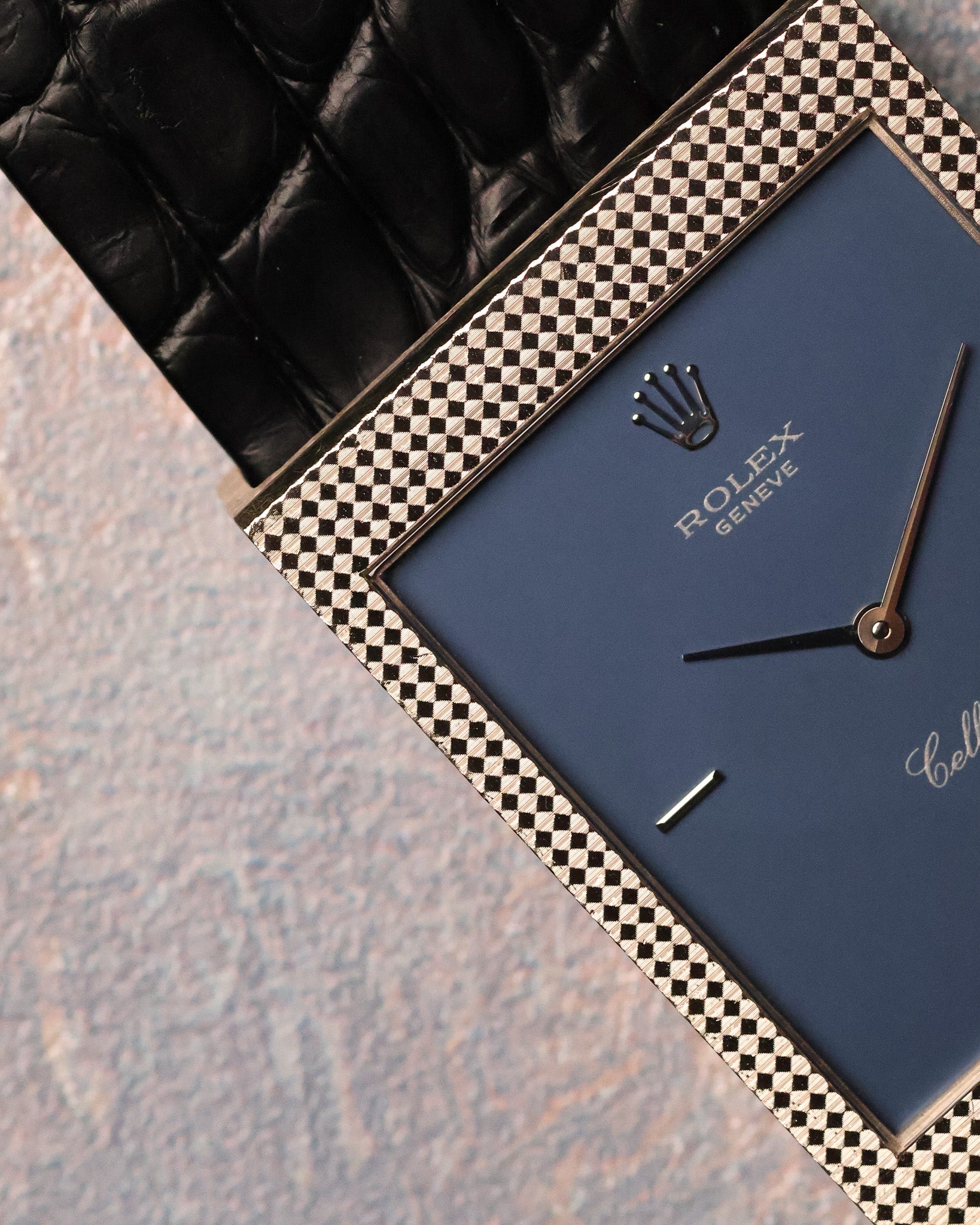 Close-up detail of the Clous de Paris hobnail engraving on the white gold case surrounding the matte blue dial.