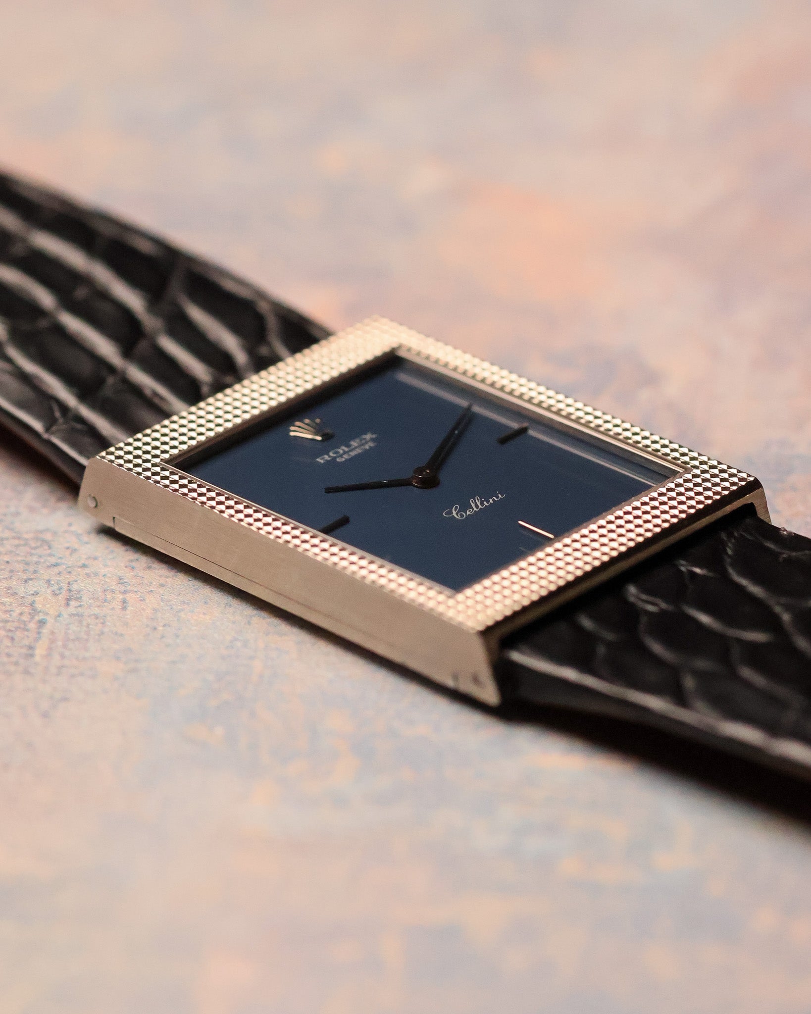 Low-angle side profile highlighting the slim rectangular case and sharp hobnail engraving of the Rolex Cellini Ref. 4127.