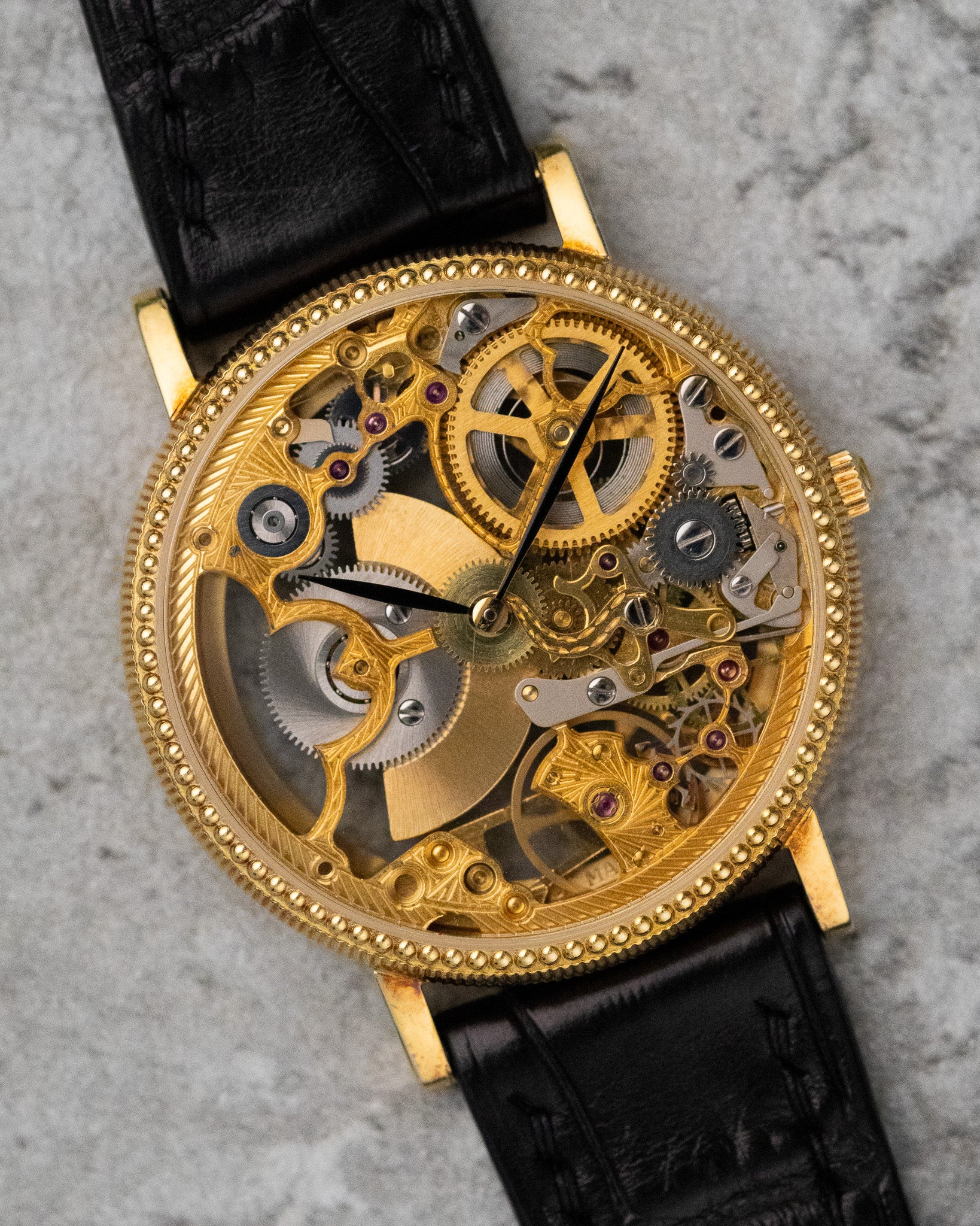 Straight-on dial view of the Universal Genève skeleton watch, focusing on the symmetrical layout of the exposed movement and slim black hands.