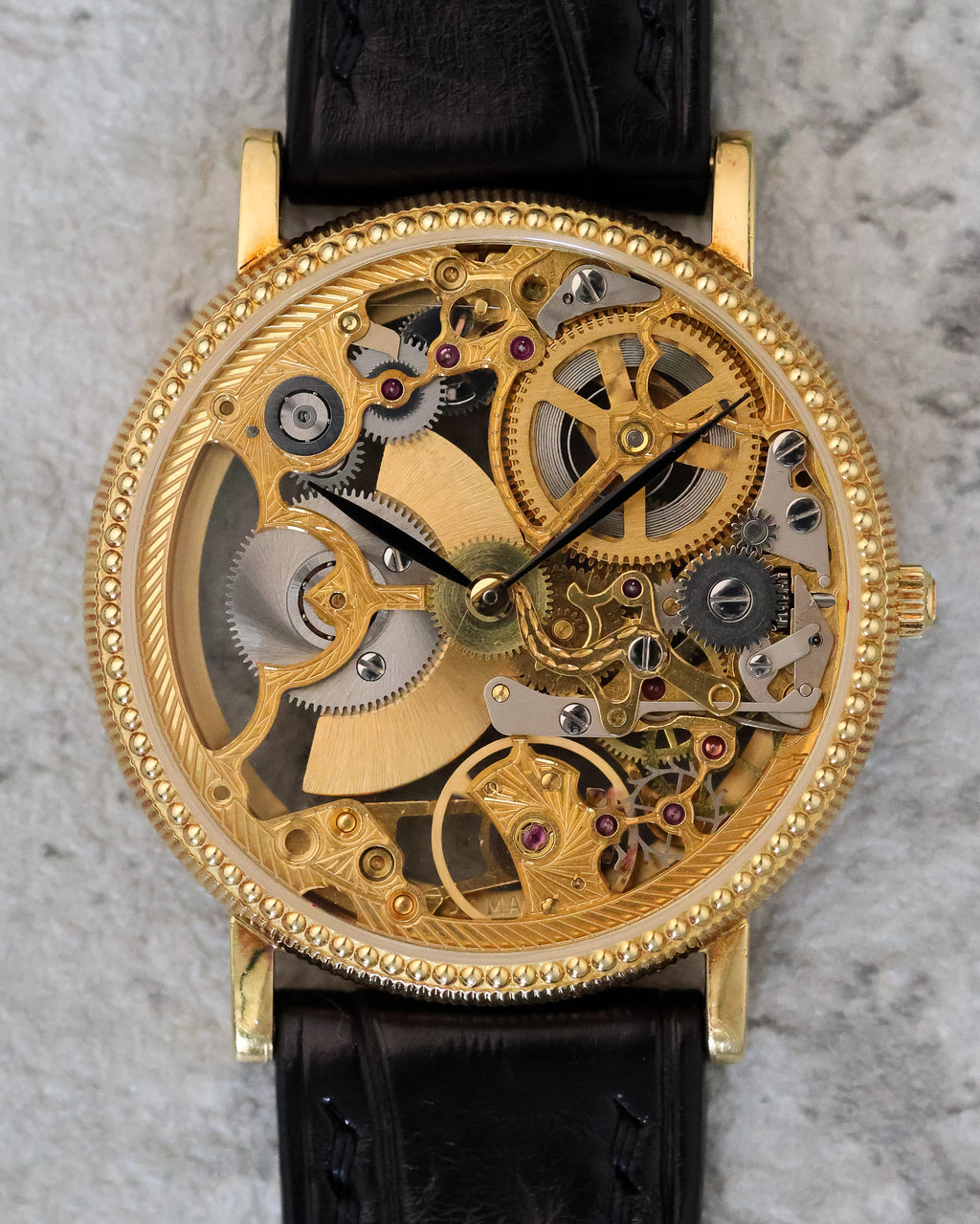 Macro detail of the skeleton dial, highlighting engraved bridges, jewel settings, and the intricate finishing of the movement.