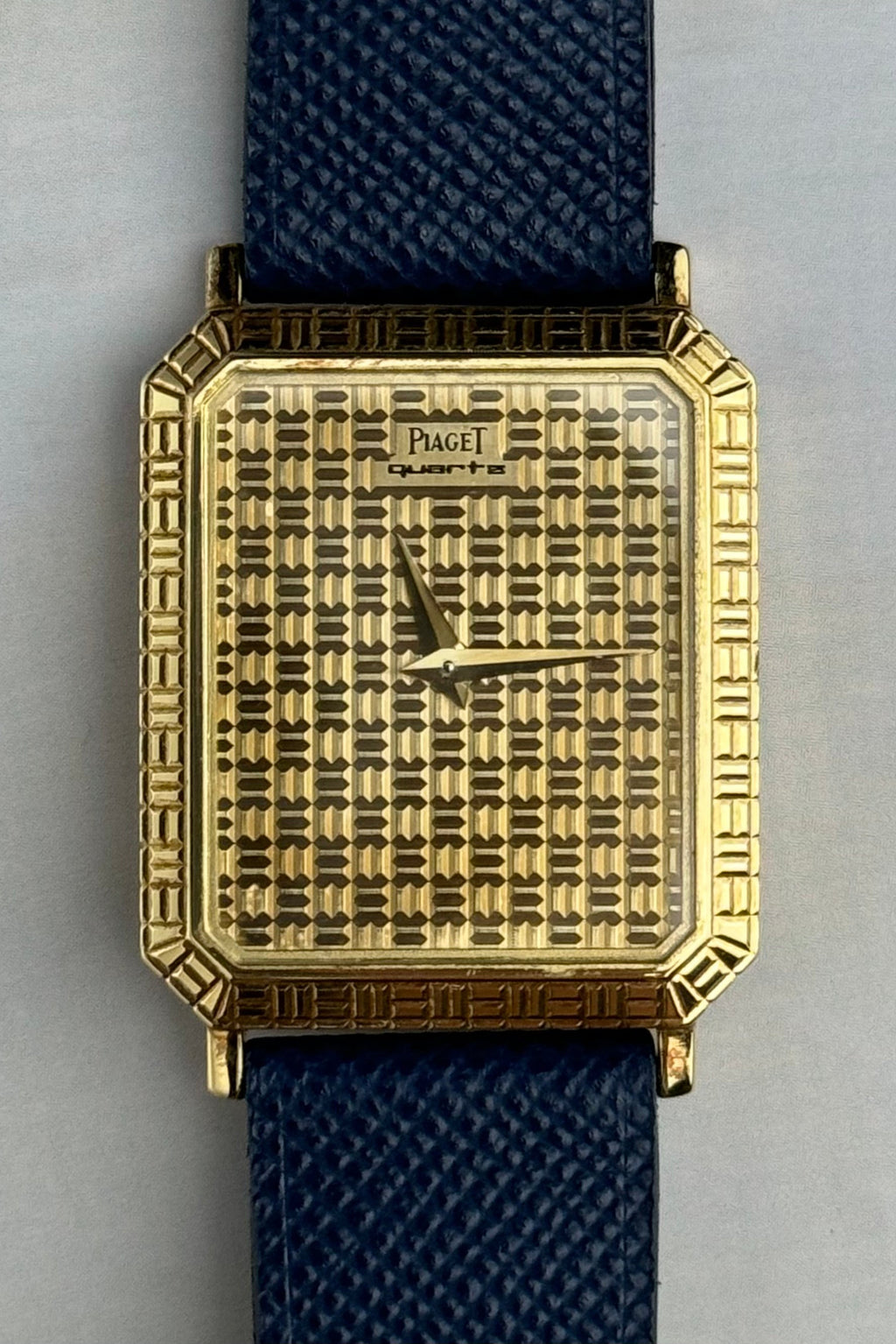 Close-up of Piaget 7143 dial showing geometric gold grid pattern and Art Deco influence