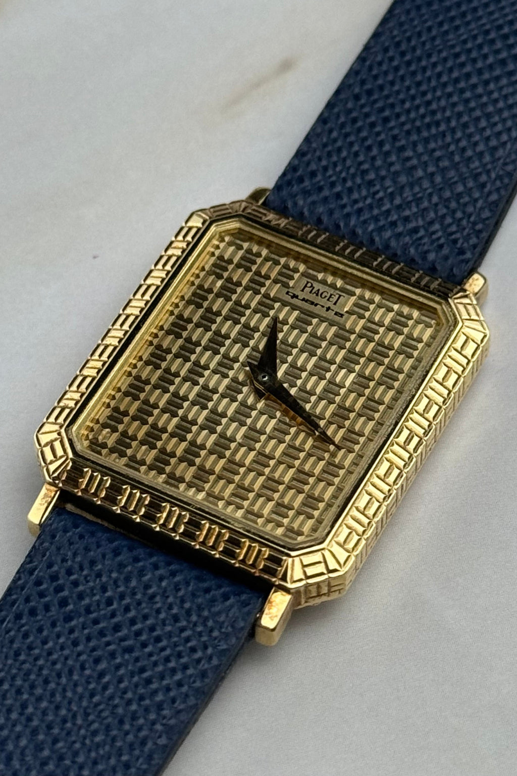 Elegant Piaget 7143 wristwatch featuring integrated gold grid motif and minimalist design, c. 1990s