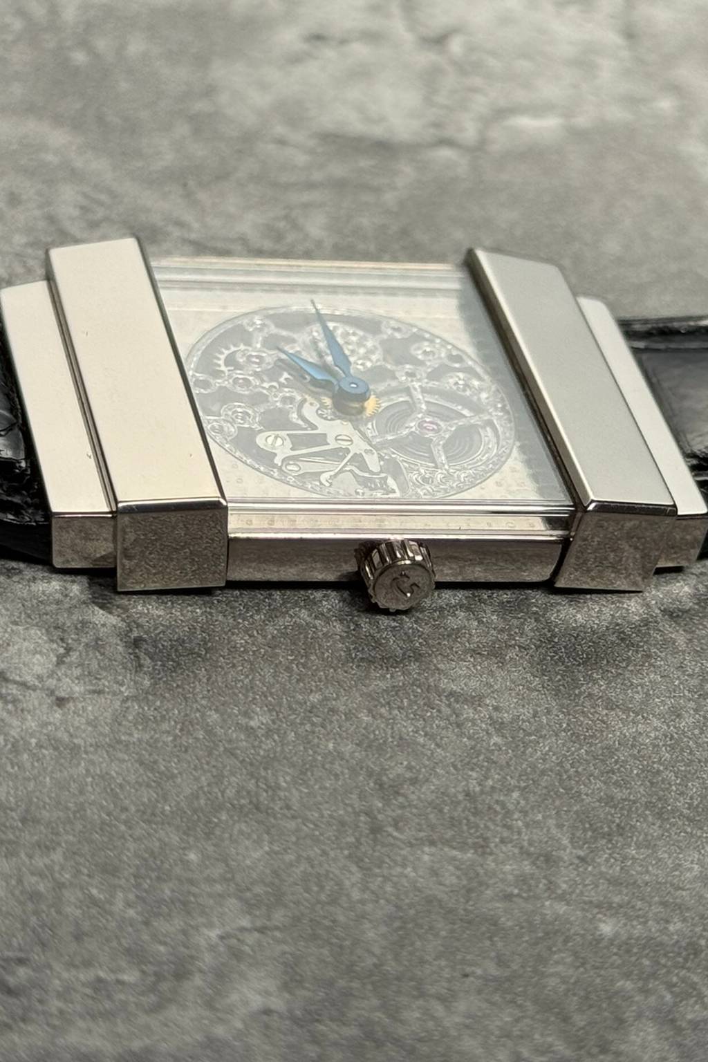 Side profile of Concord Crystal Skeleton watch with 18K white gold top hat case and skeleton architecture