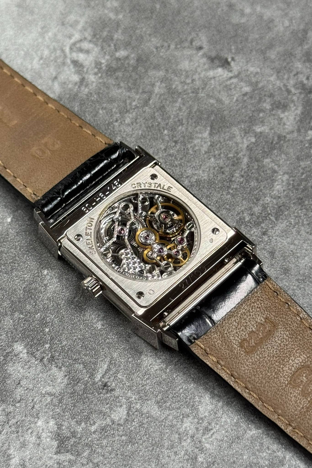 Exhibition case back of Concord Crystal Skeleton showing engraved Peseux 7000 manual movement in white gold case