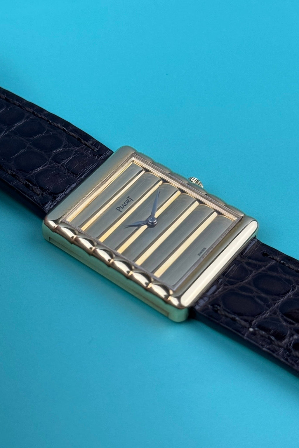 Close-up of Piaget 91480 dial featuring vertically ribbed 18K gold texture and matching gold baton hands