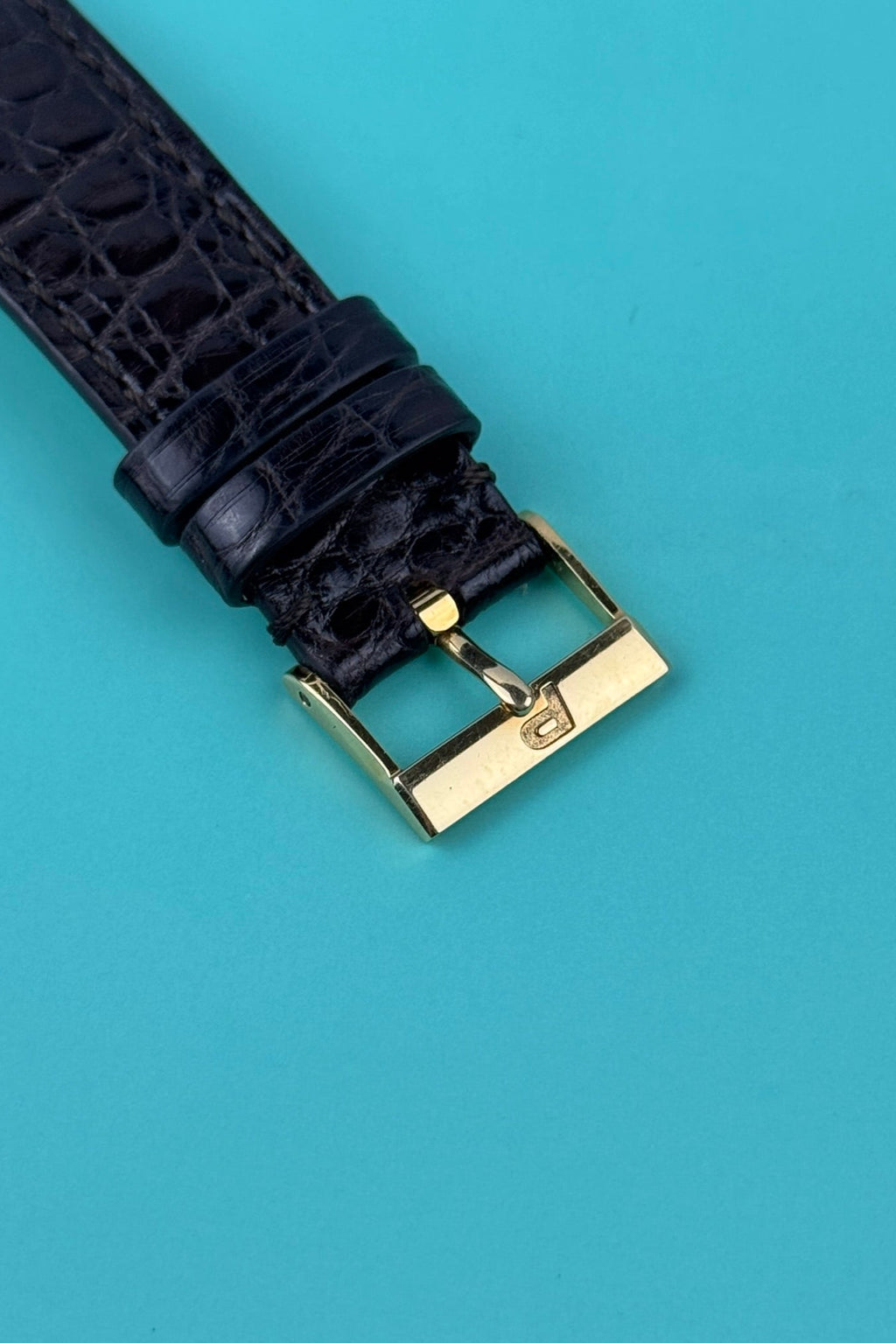 Original Piaget 18K yellow gold buckle paired with black leather strap on Ref. 91480 vintage watch