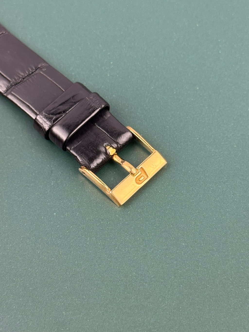 Gold-tone Piaget buckle paired with classic leather strap on Ref. 9254 vintage tank watch