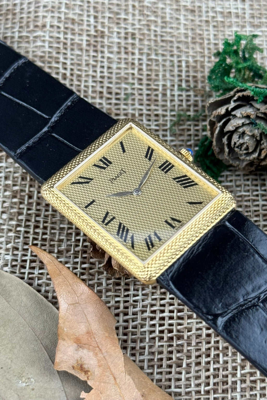 Elegant Piaget 9152 rectangular gold watch with matching guilloché case and dial, featuring slim gold hands