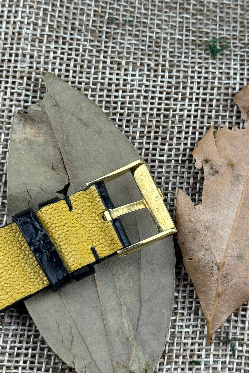 Close-up of Piaget-signed gold buckle on black leather strap, part of Ref. 9152 vintage dress watch