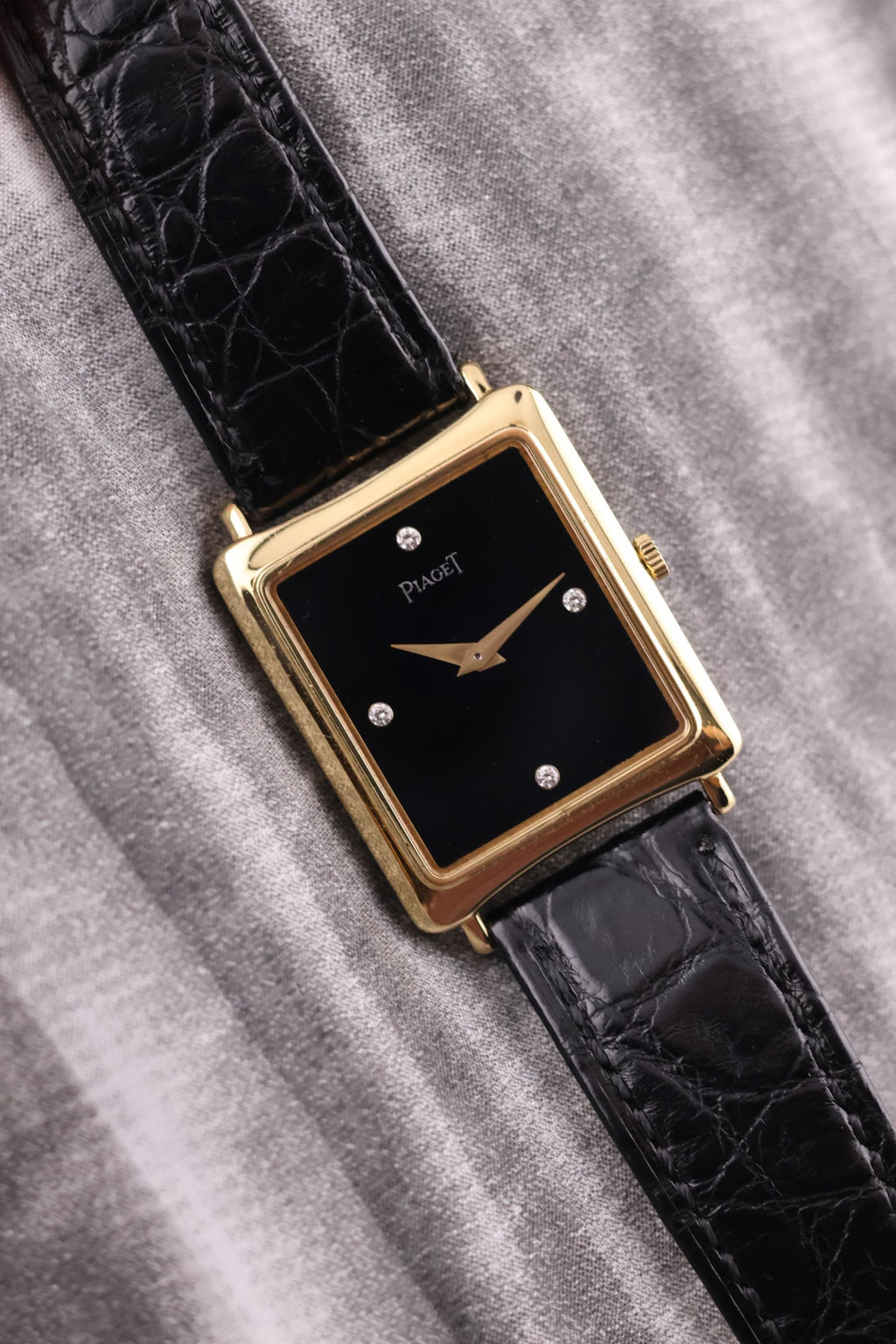Front view of the vintage Piaget 9251 watch in 18K yellow gold, featuring a black onyx dial with diamond markers at 3, 6, 9, and 12 o’clock.