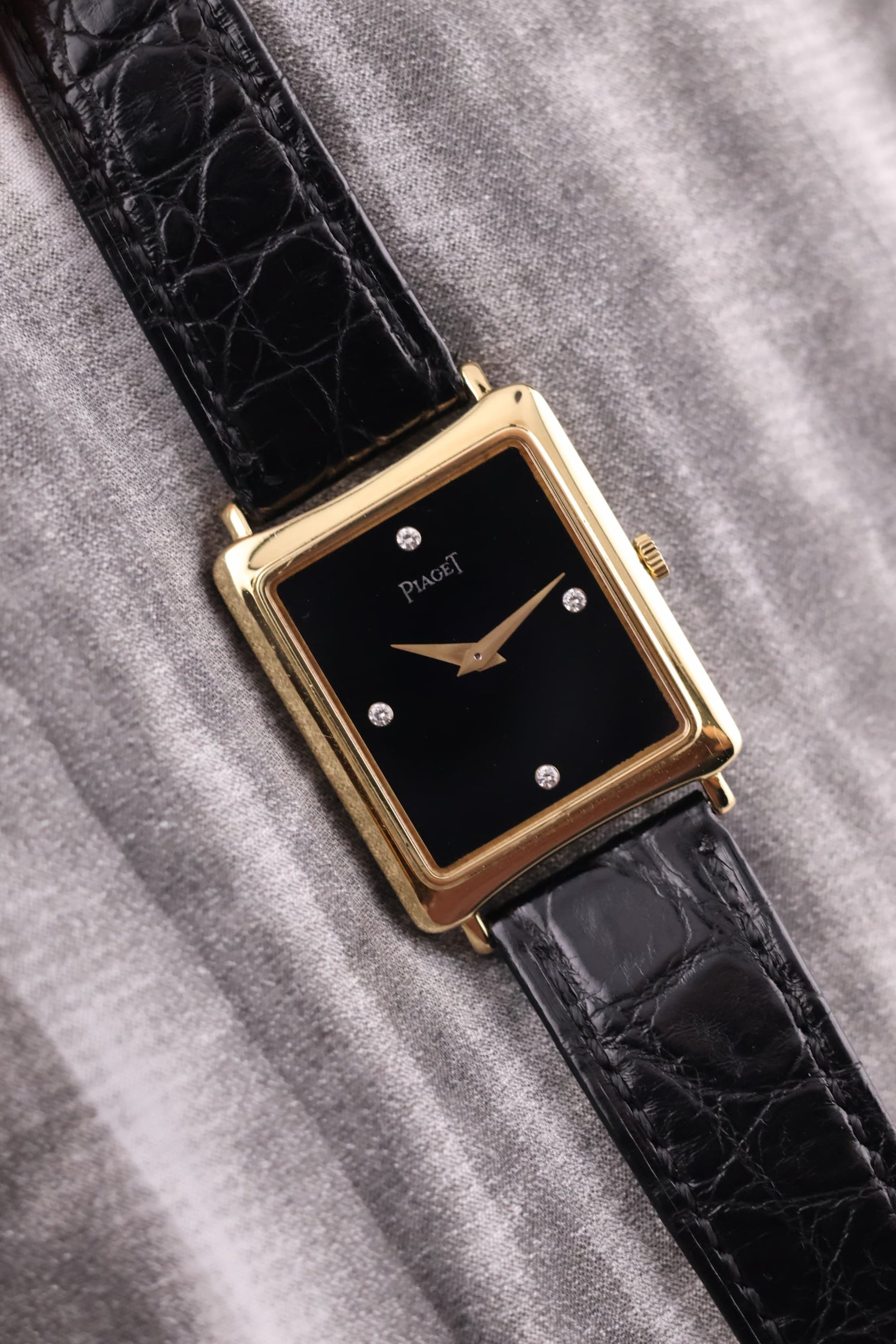 Front view of the vintage Piaget 9251 watch in 18K yellow gold, featuring a black onyx dial with diamond markers at 3, 6, 9, and 12 o’clock.