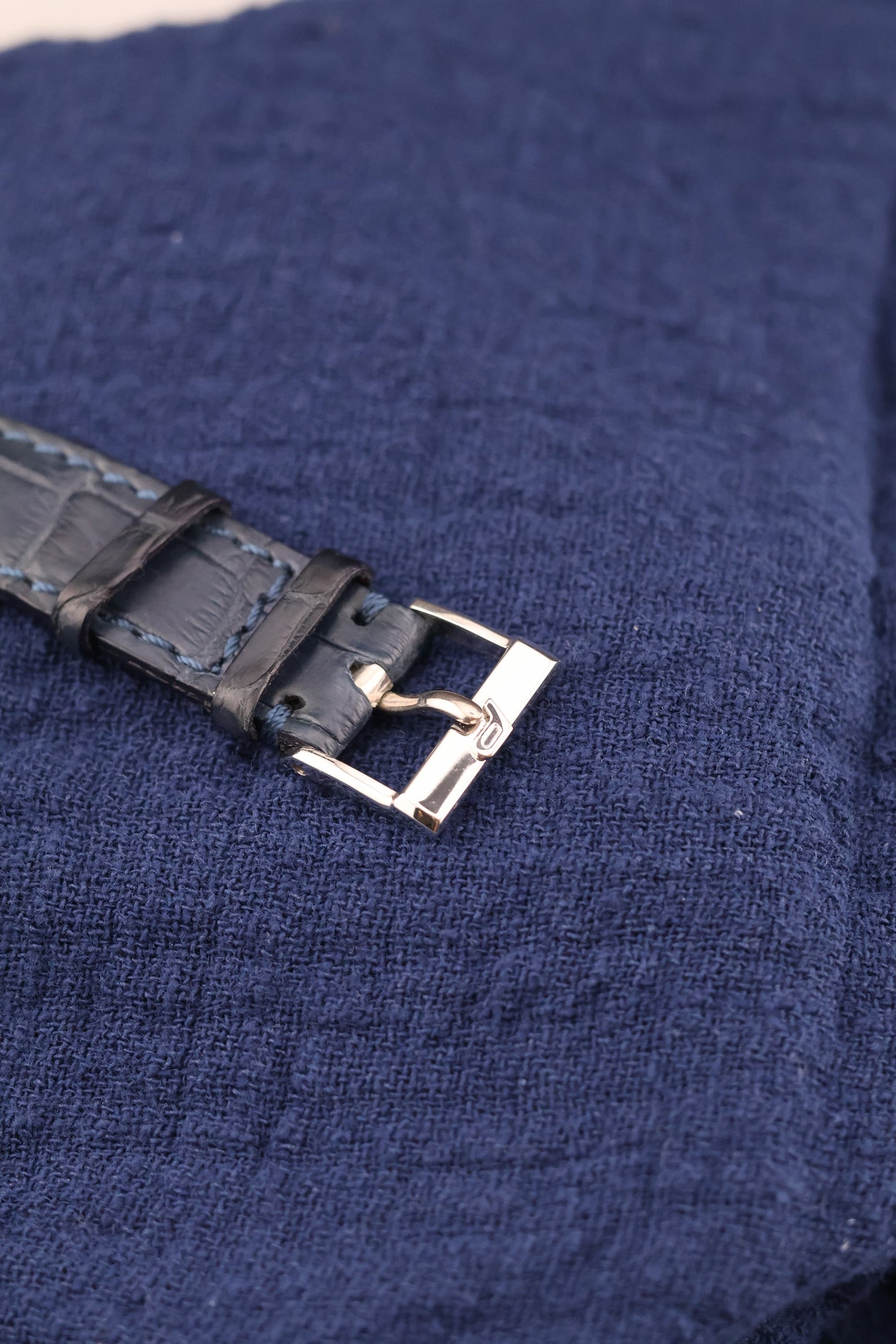 Original Piaget 18K white gold buckle with blue sapphire cabochon, paired with leather strap