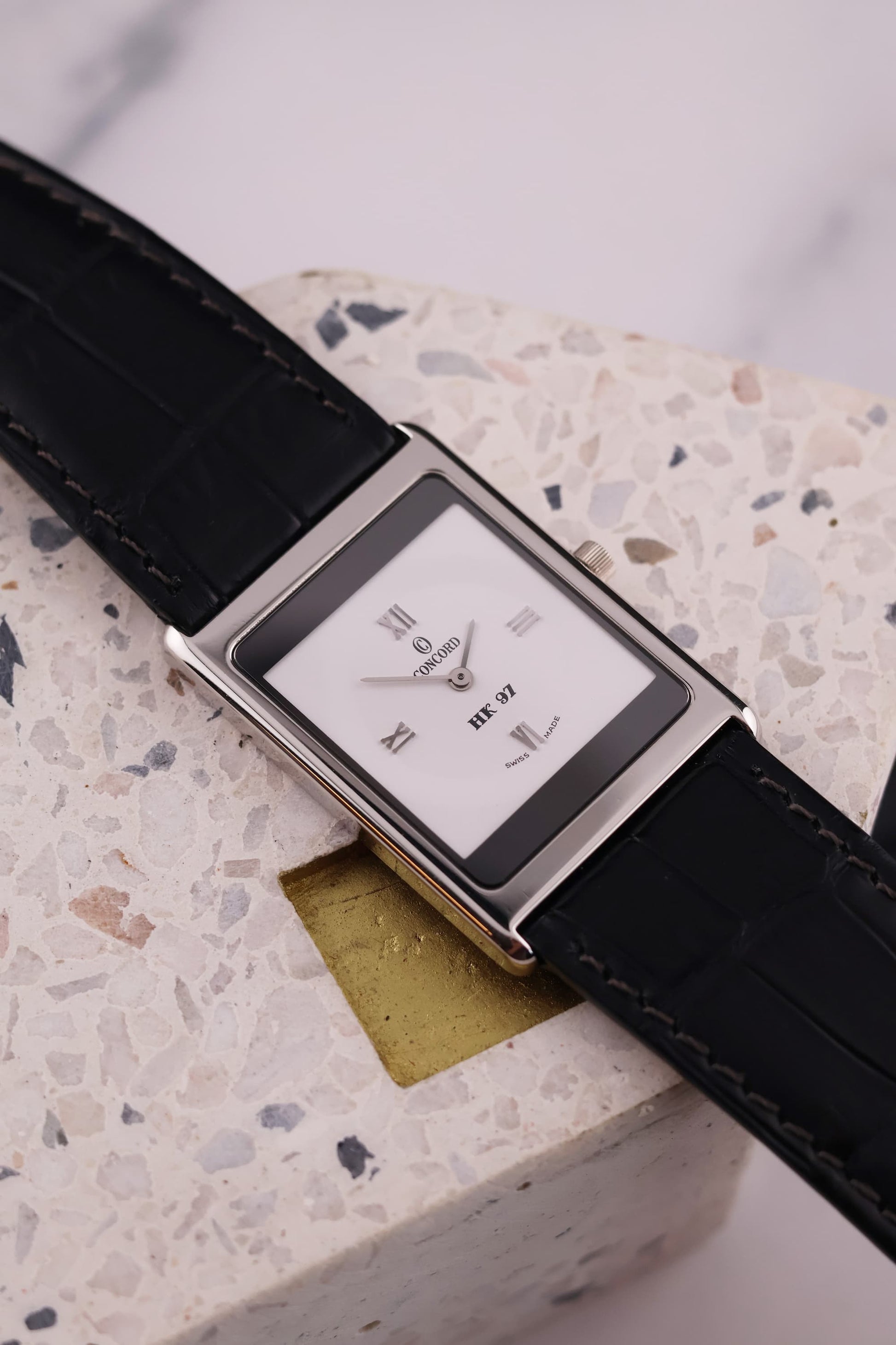 Front-facing view of the Concord Delirium 1997 Hong Kong Limited Edition, showcasing the white dial with Roman numerals, “HK 97” inscription, and platinum case.