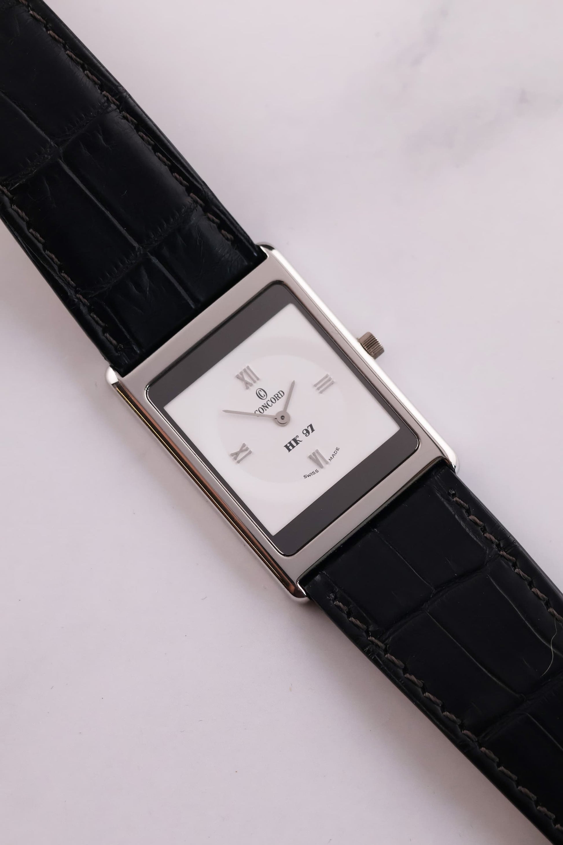 Full view of the Concord Delirium 1997 with black alligator strap, illustrating its slim profile and elegant proportions.