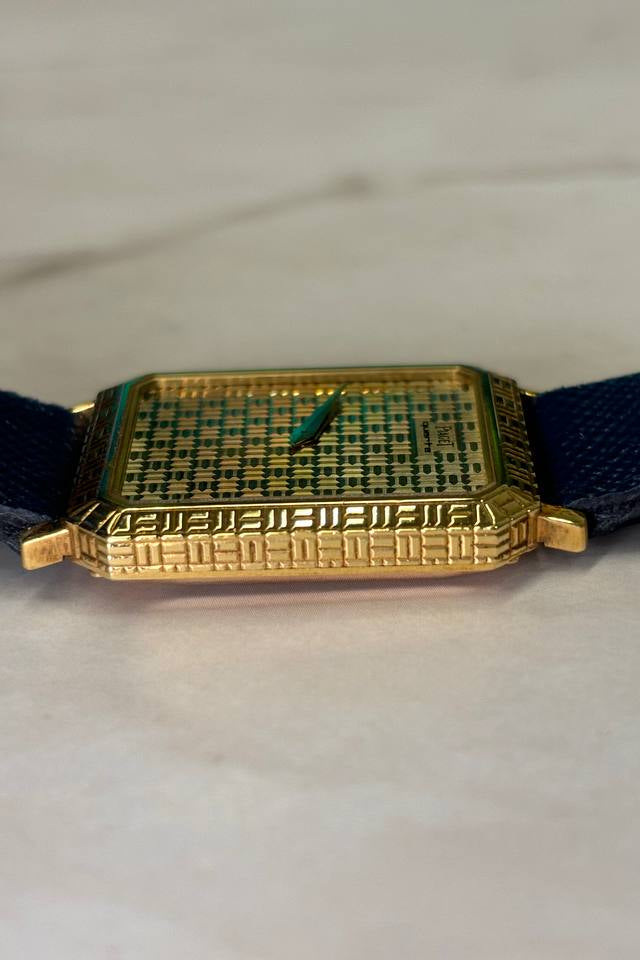 Angular side view of Piaget Ref. 7143 highlighting Art Deco grid structure in yellow gold case