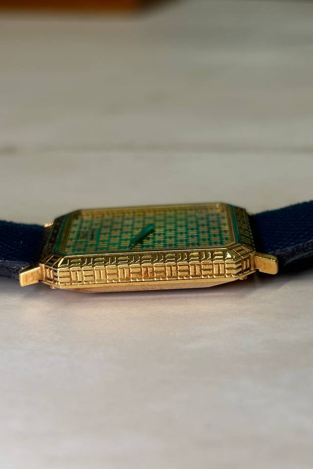 Side profile of Piaget 7143 watch showcasing slim 18K yellow gold case and integrated design